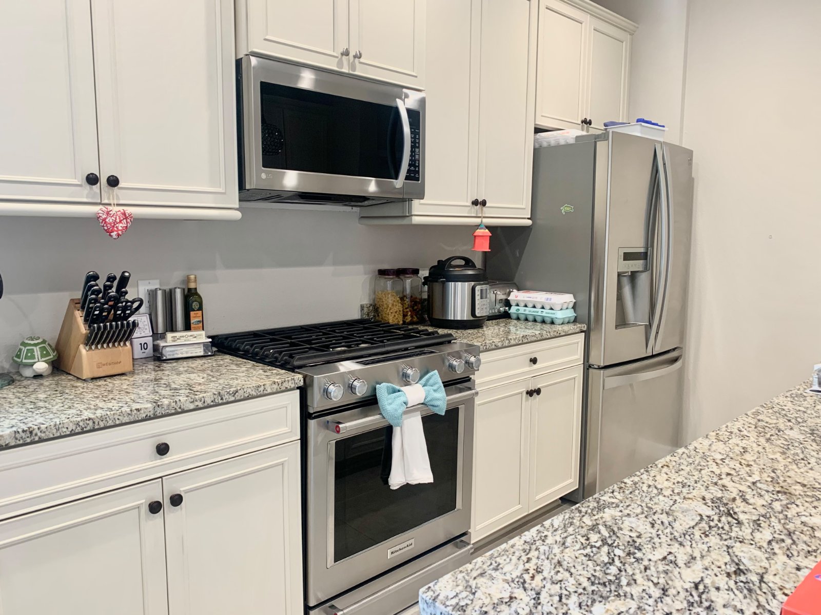 Clean kitchen with white cabinets and granite countertops